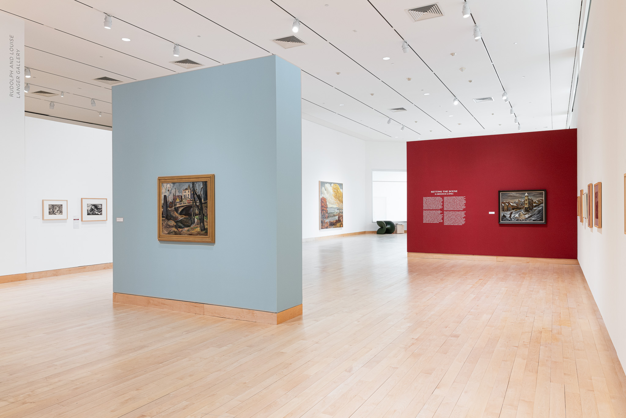 A gallery installation with prints and paintings depicting 1930-40s farm life.