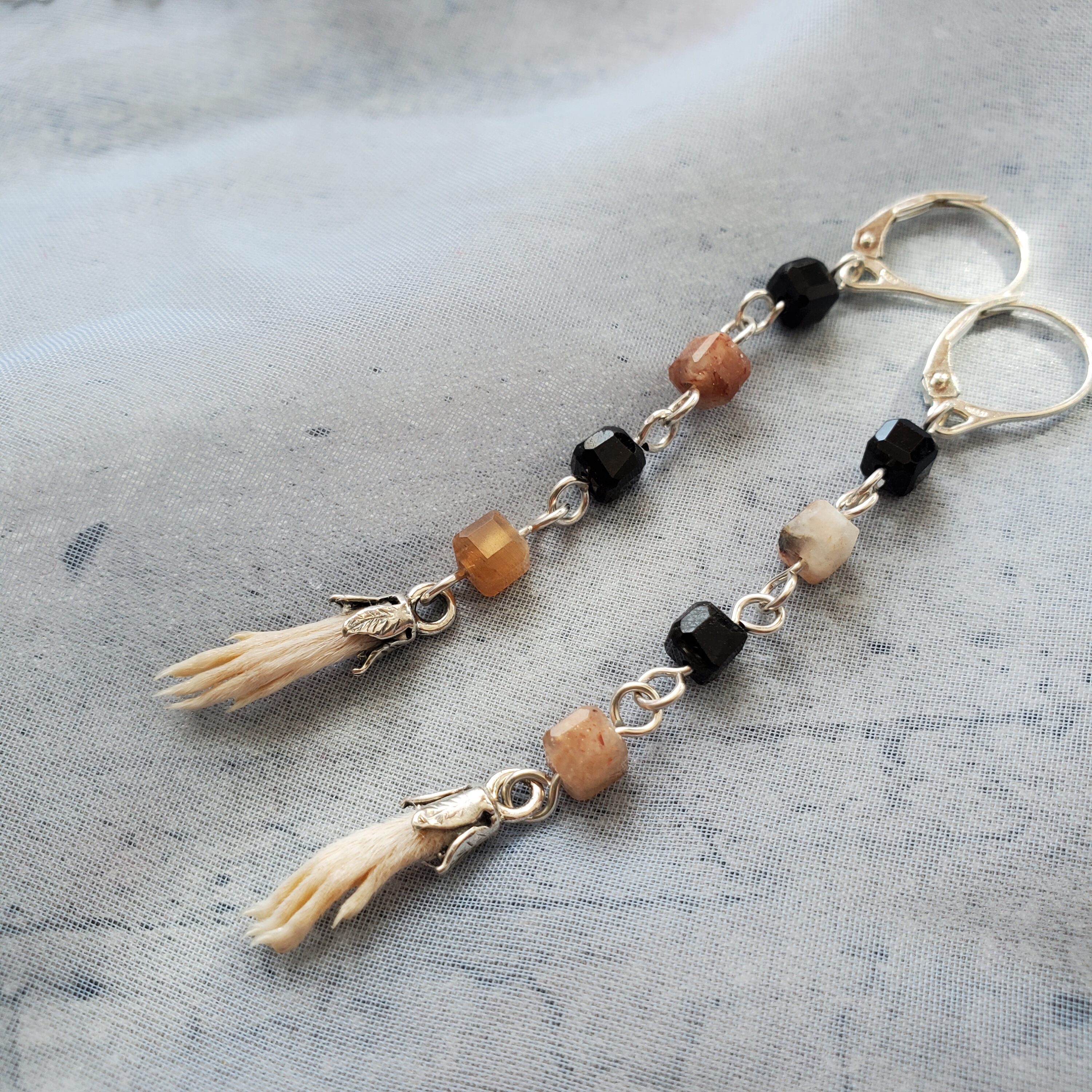 Earrings with silver, beads, and animal feet