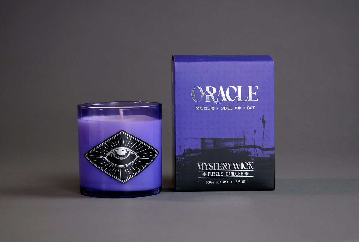 A purple candle and box against a grey background