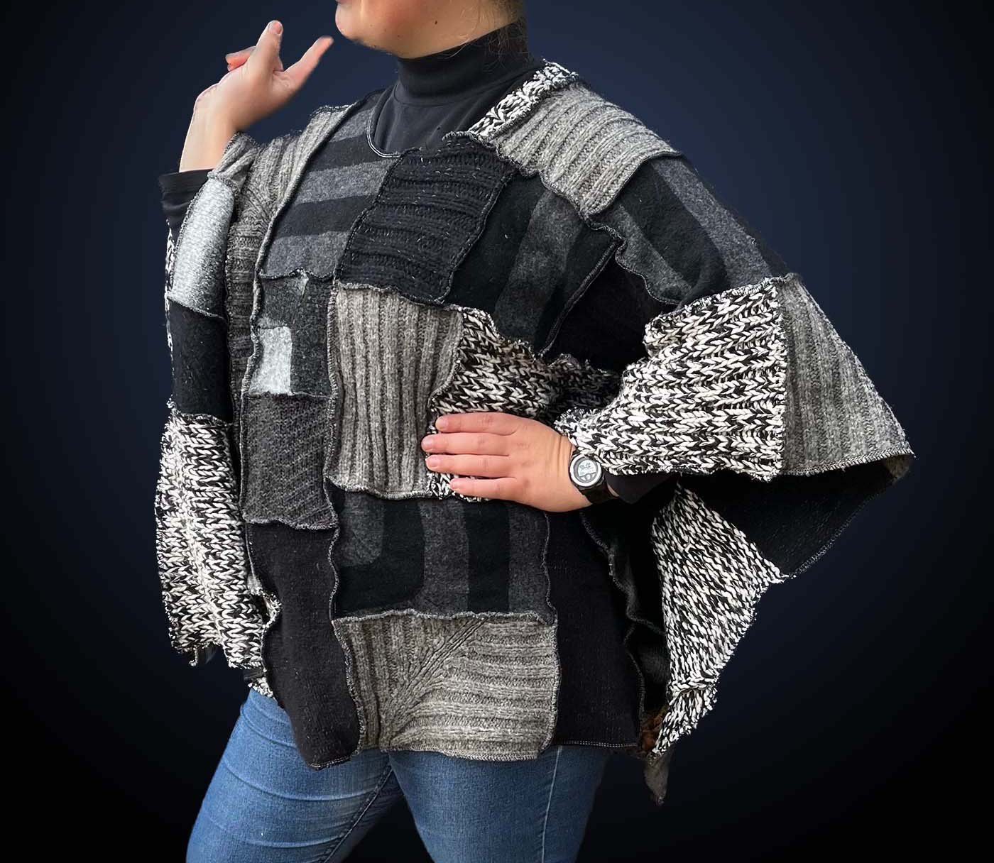 A model wearing a black, grey, white sweater