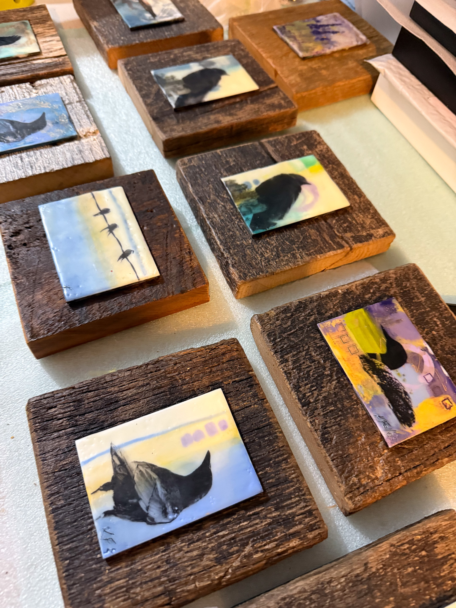 A series of artwork depicting landscapes and birds.