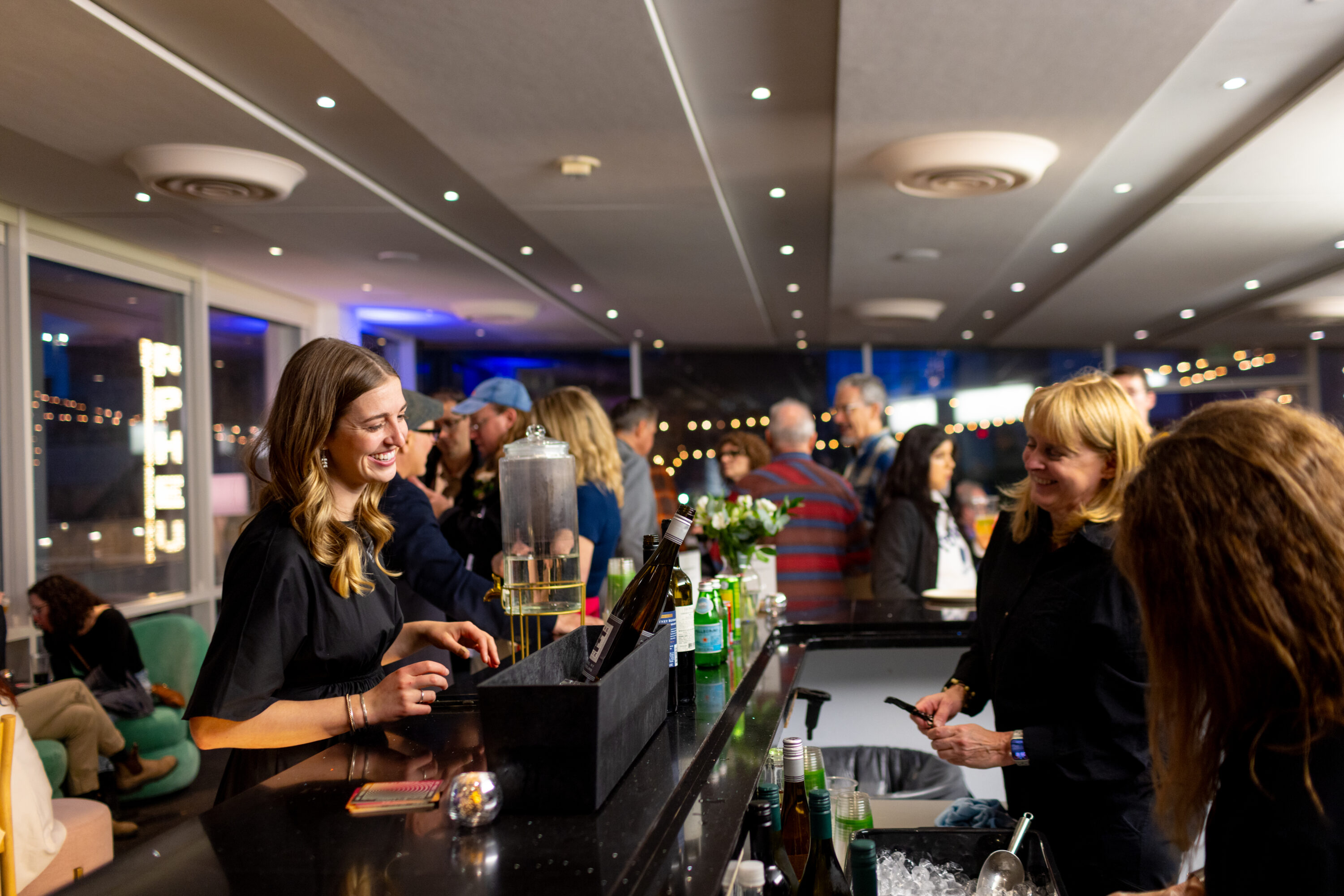 Someone ordering a drink at a bar.