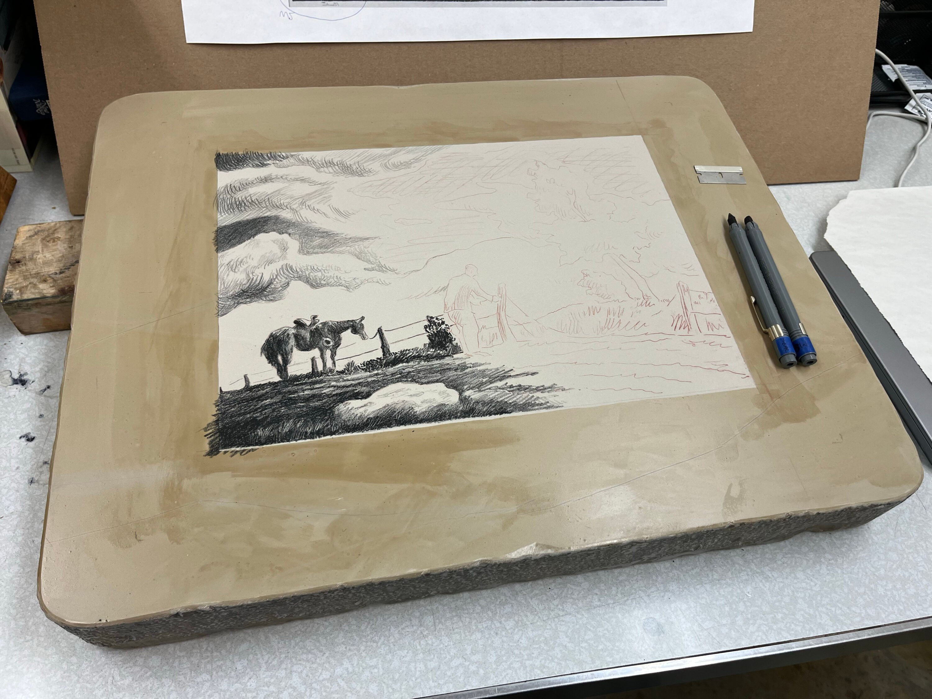 A lithograph in the process of being drawn.