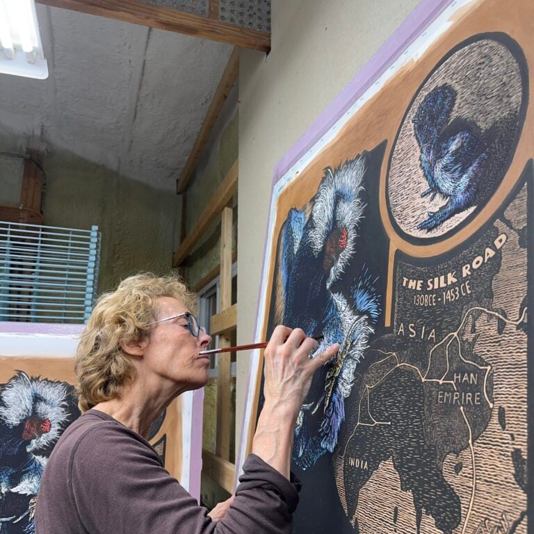 Someone working on a large scale artwork.