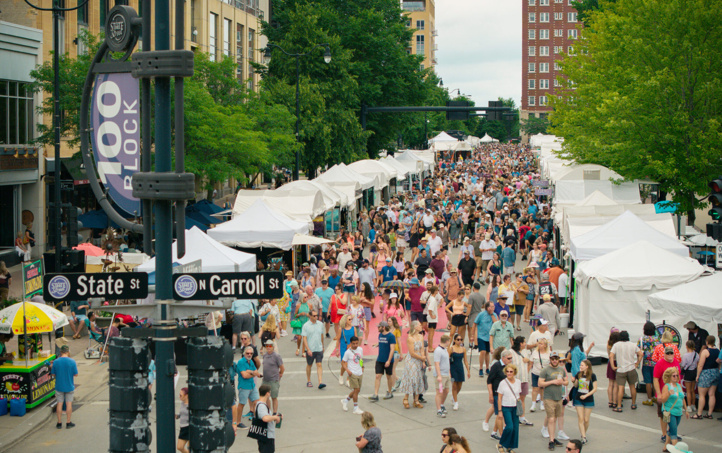 A group of people around the capital square in madison.