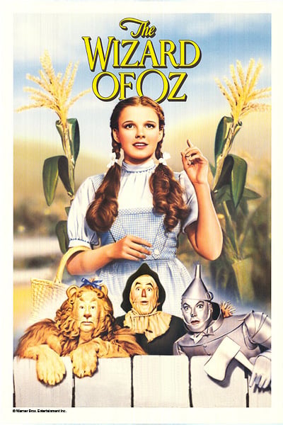 "The Wizard of Oz" with a girl in the middle of a scarecrow, tin man and lion.