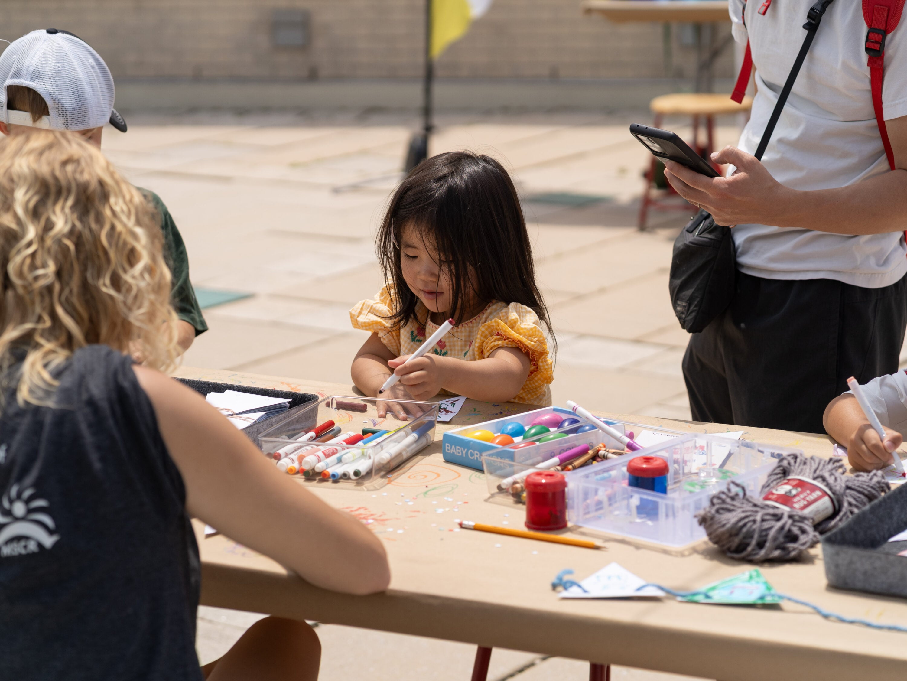 Kids drawing with markers.