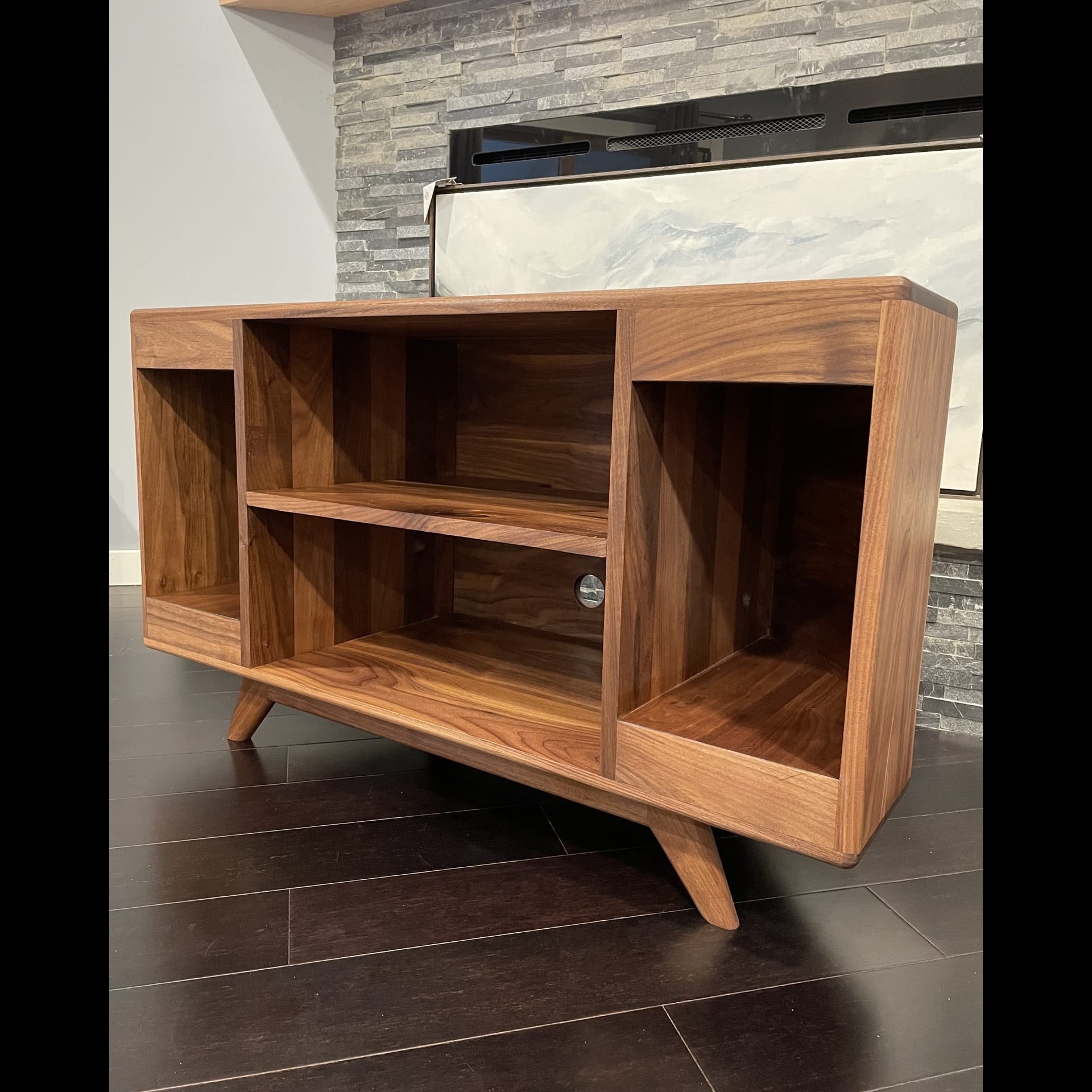A wooden TV stand with numerous drawers.