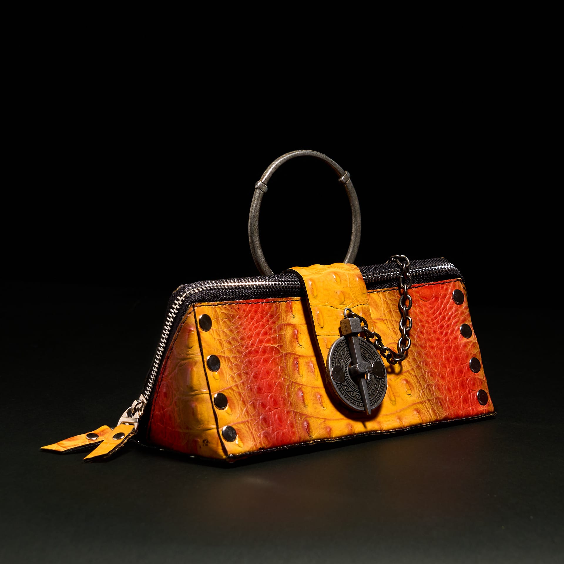 An orange and red leather hand bag.
