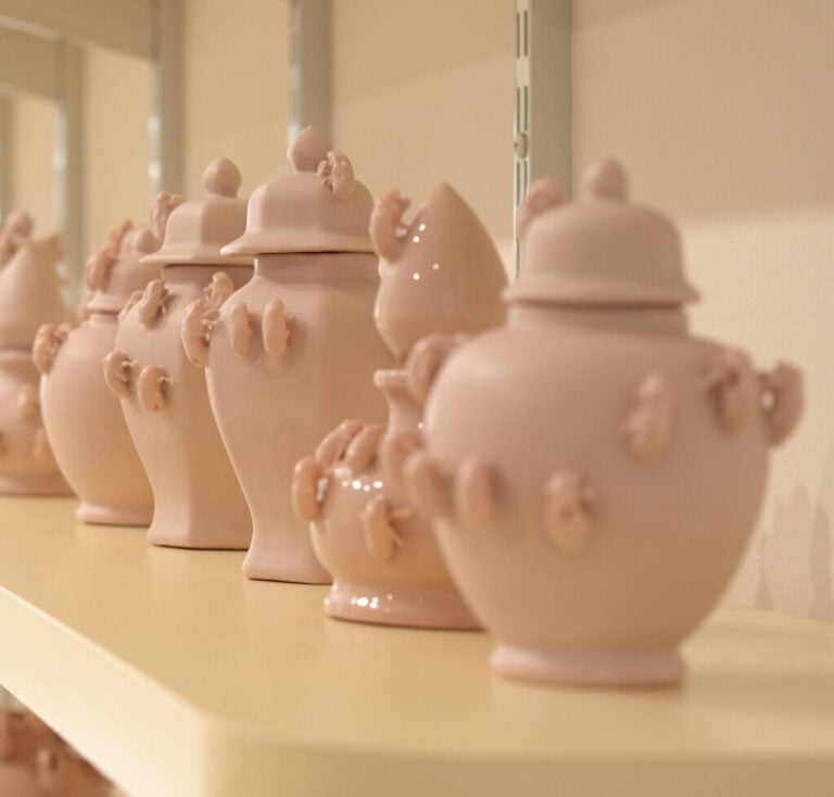 Ceramic vases with cicada shells on them.
