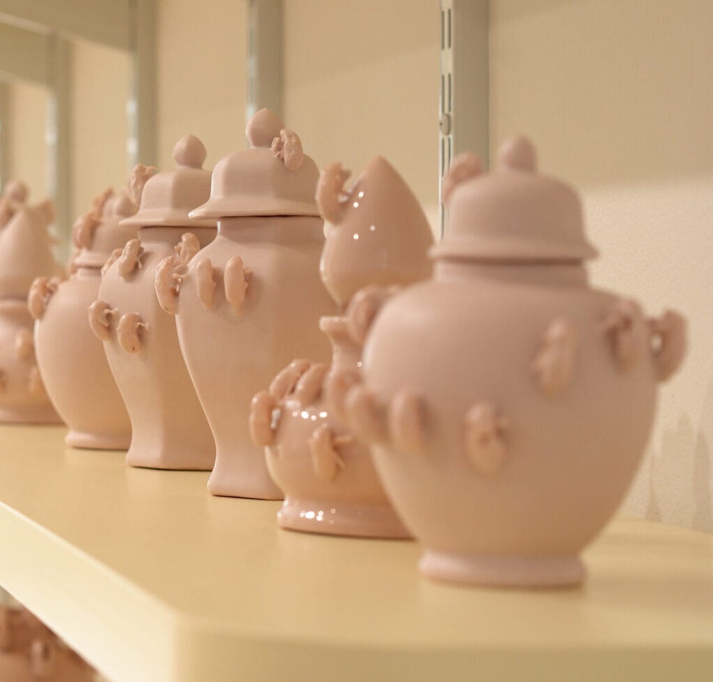 Ceramic vases with cicada shells on them.