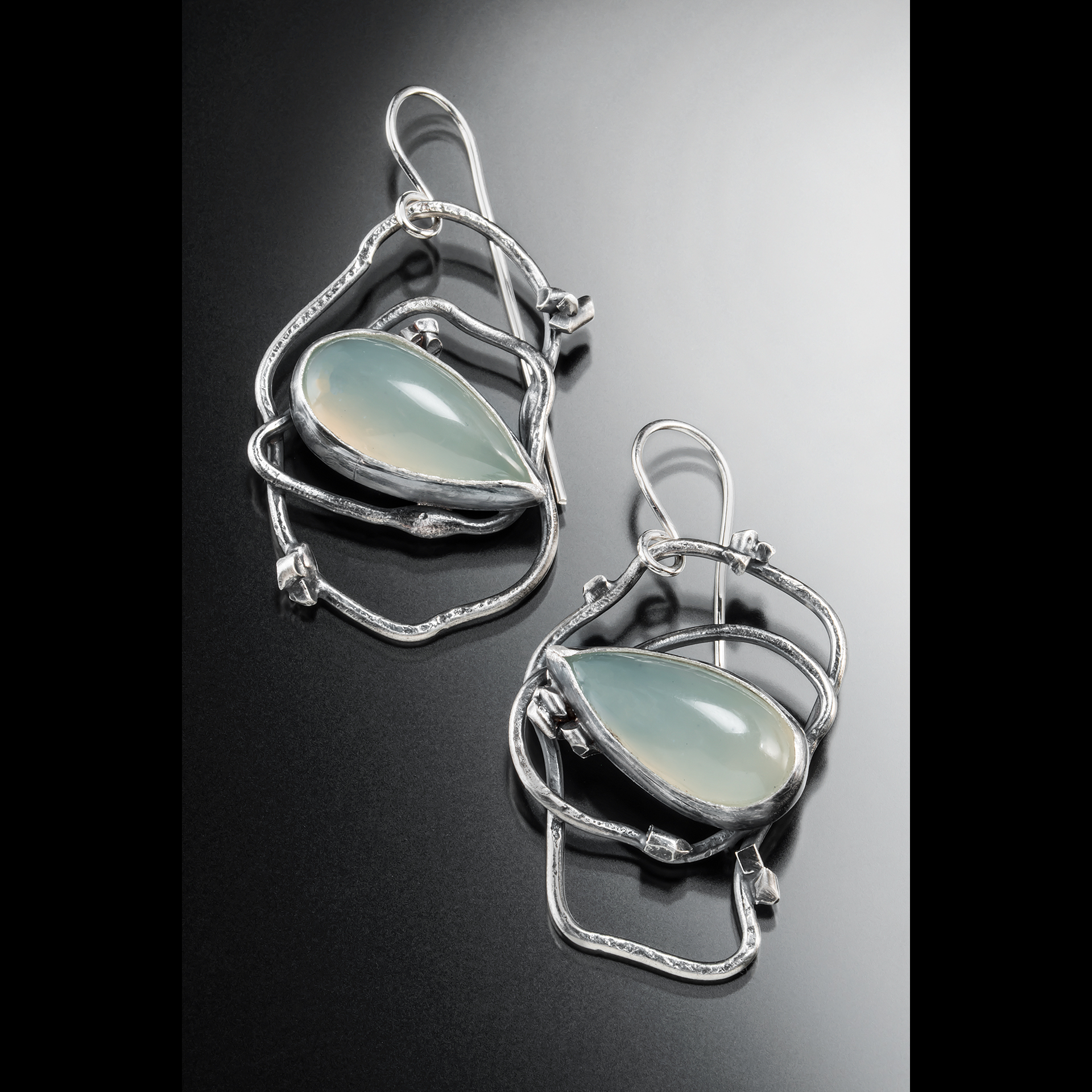 Earrings with wires and light blue stones.