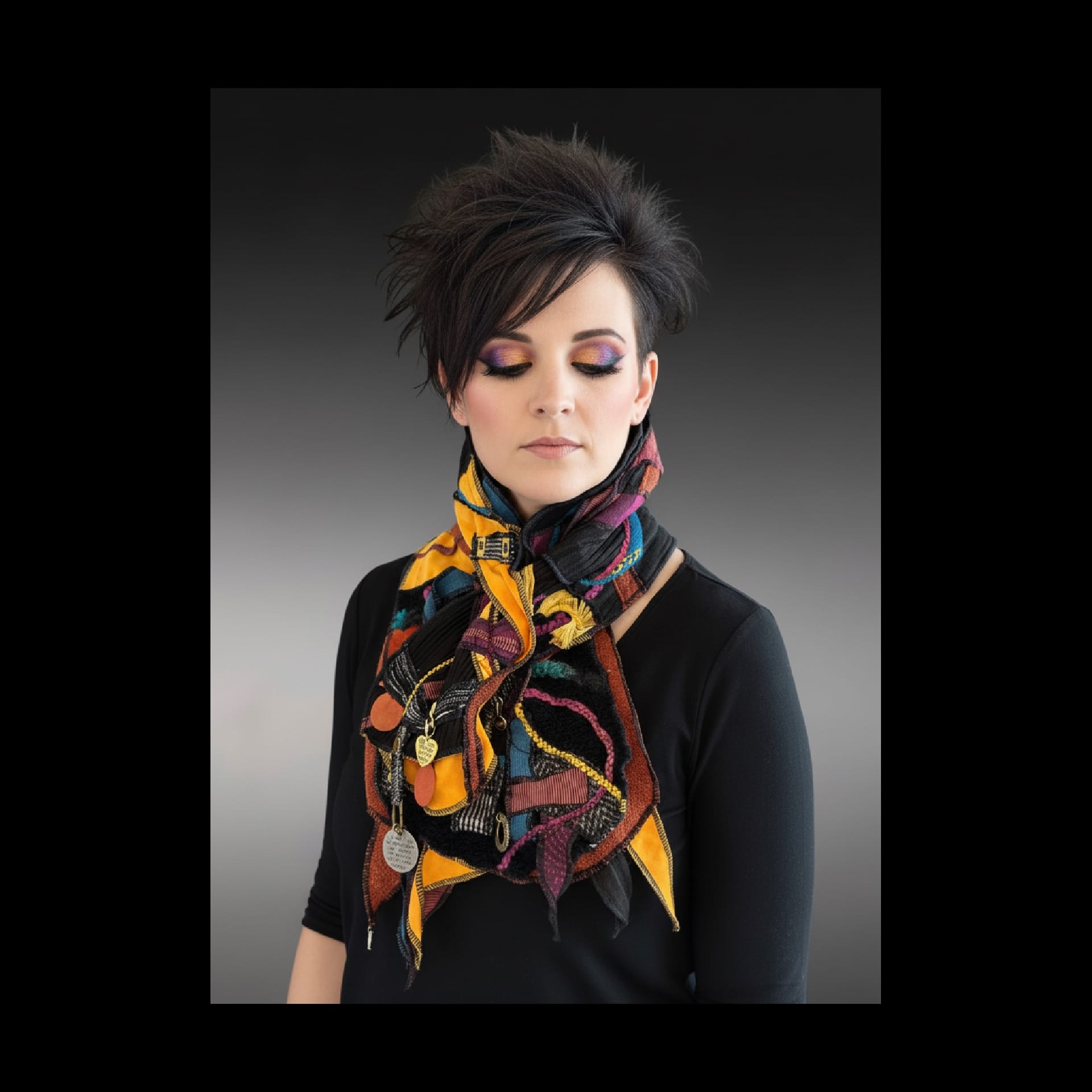 A colorful scarf on a woman with short hair.