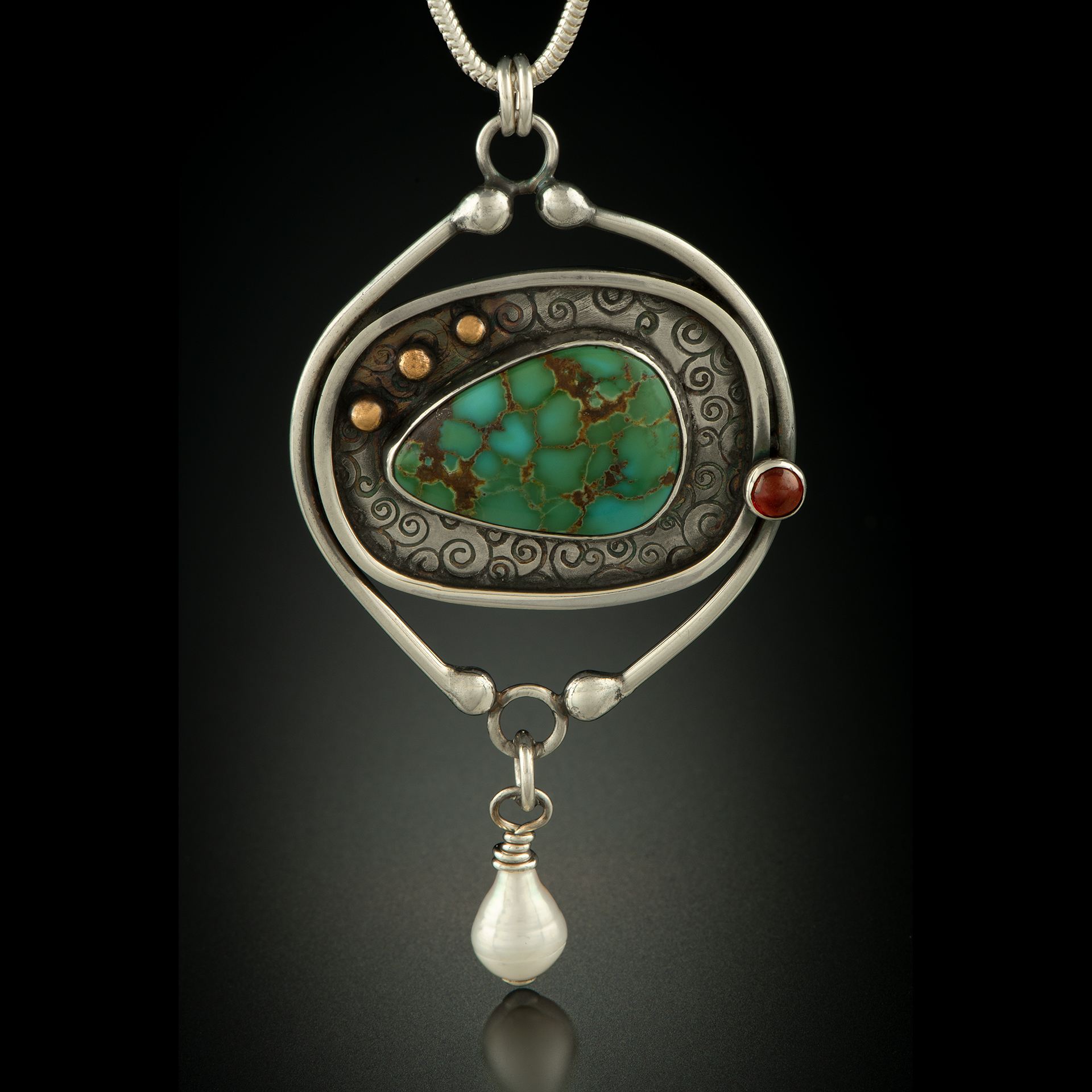 A necklace with wire around a green pendant.