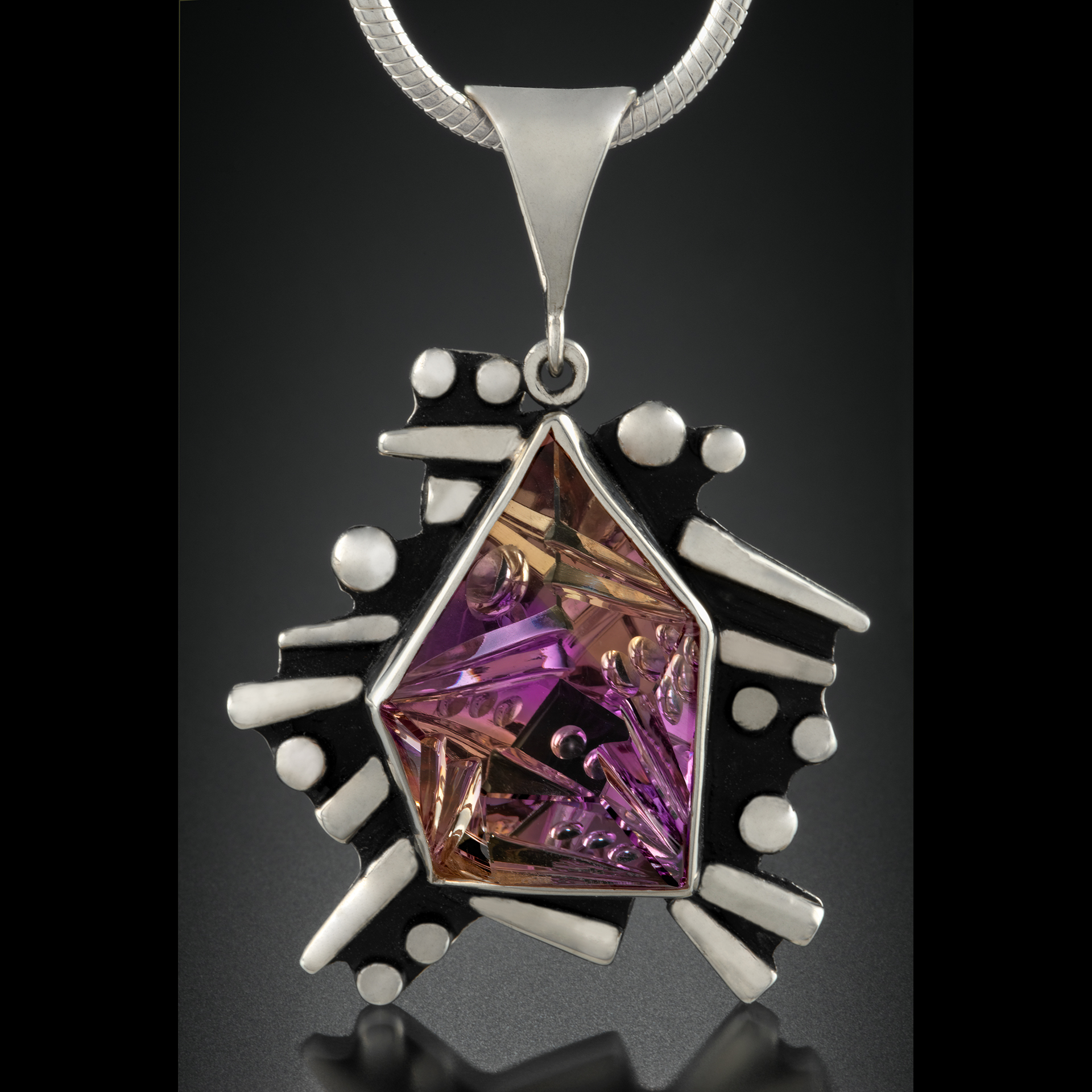 A silver necklace with purple and yellow.