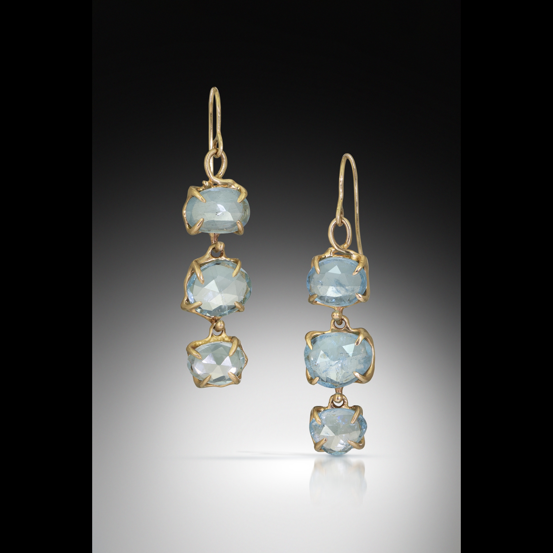 Dangly gold and light blue earrings.