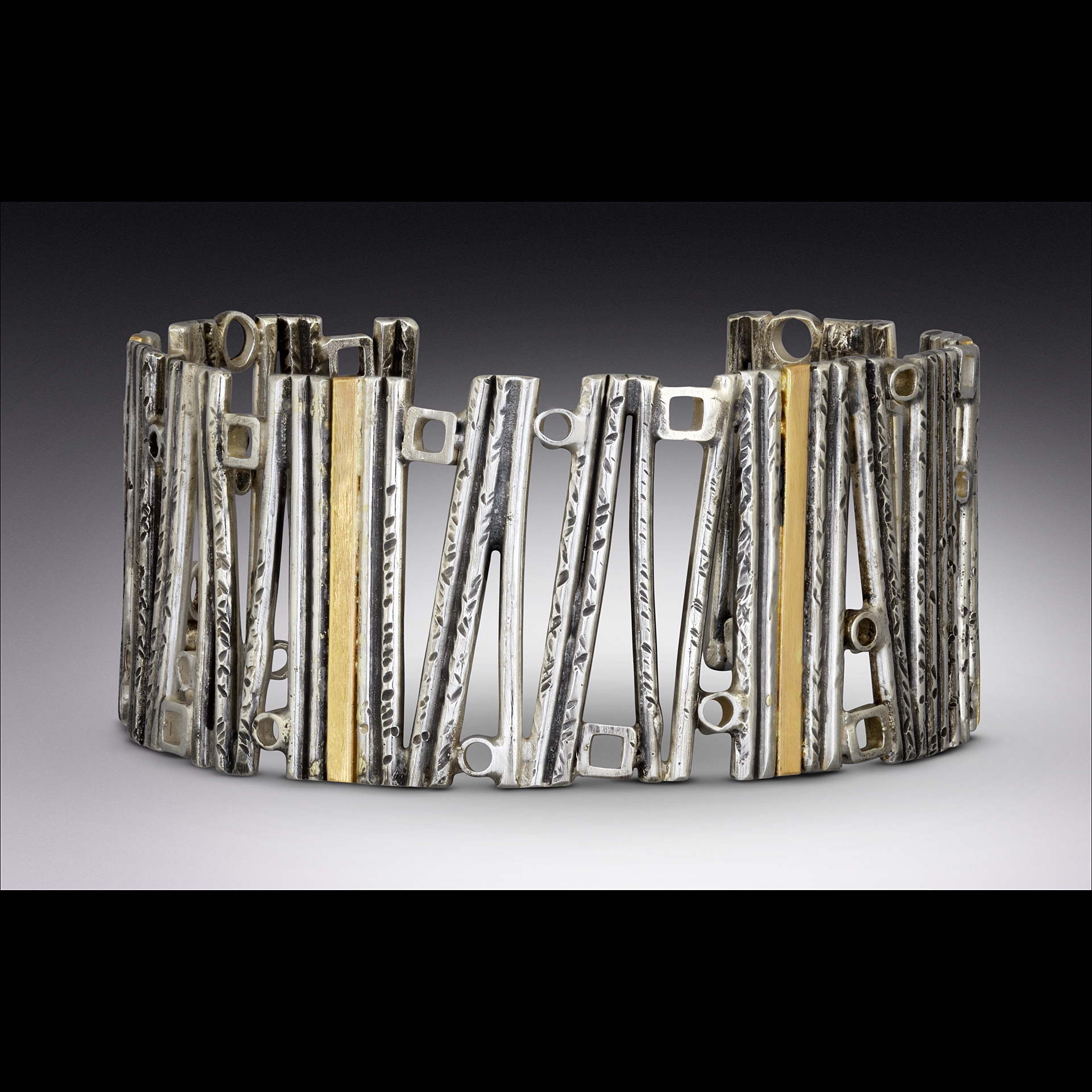 A silver and gold bracelet.