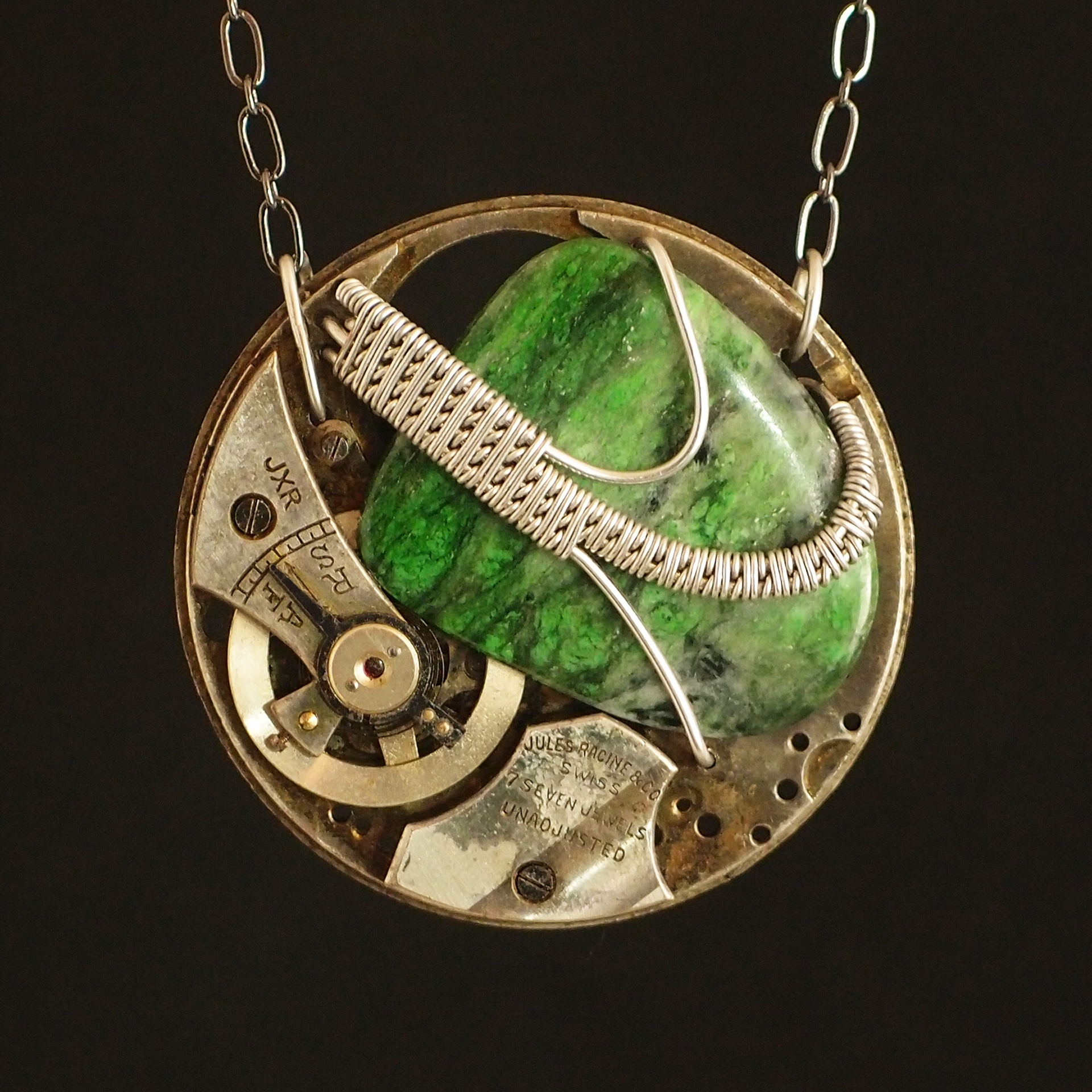A gold and green pendant.