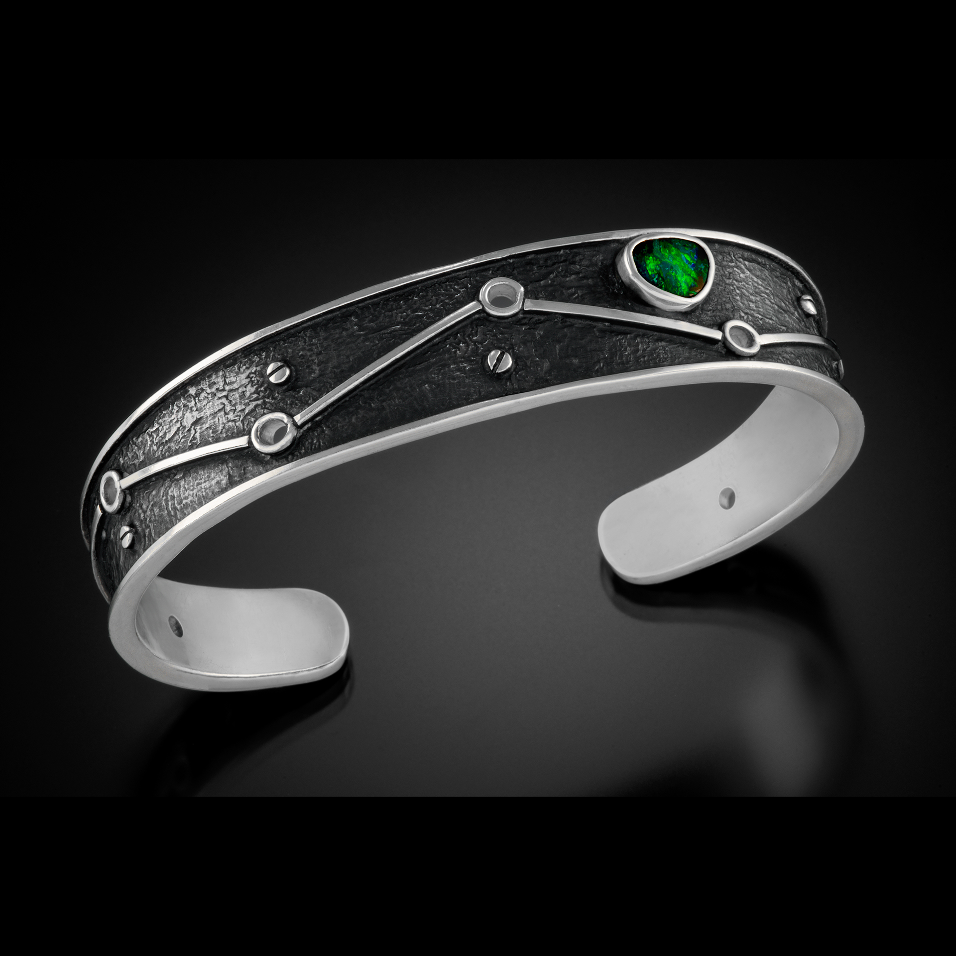 A silver bracelet with green.
