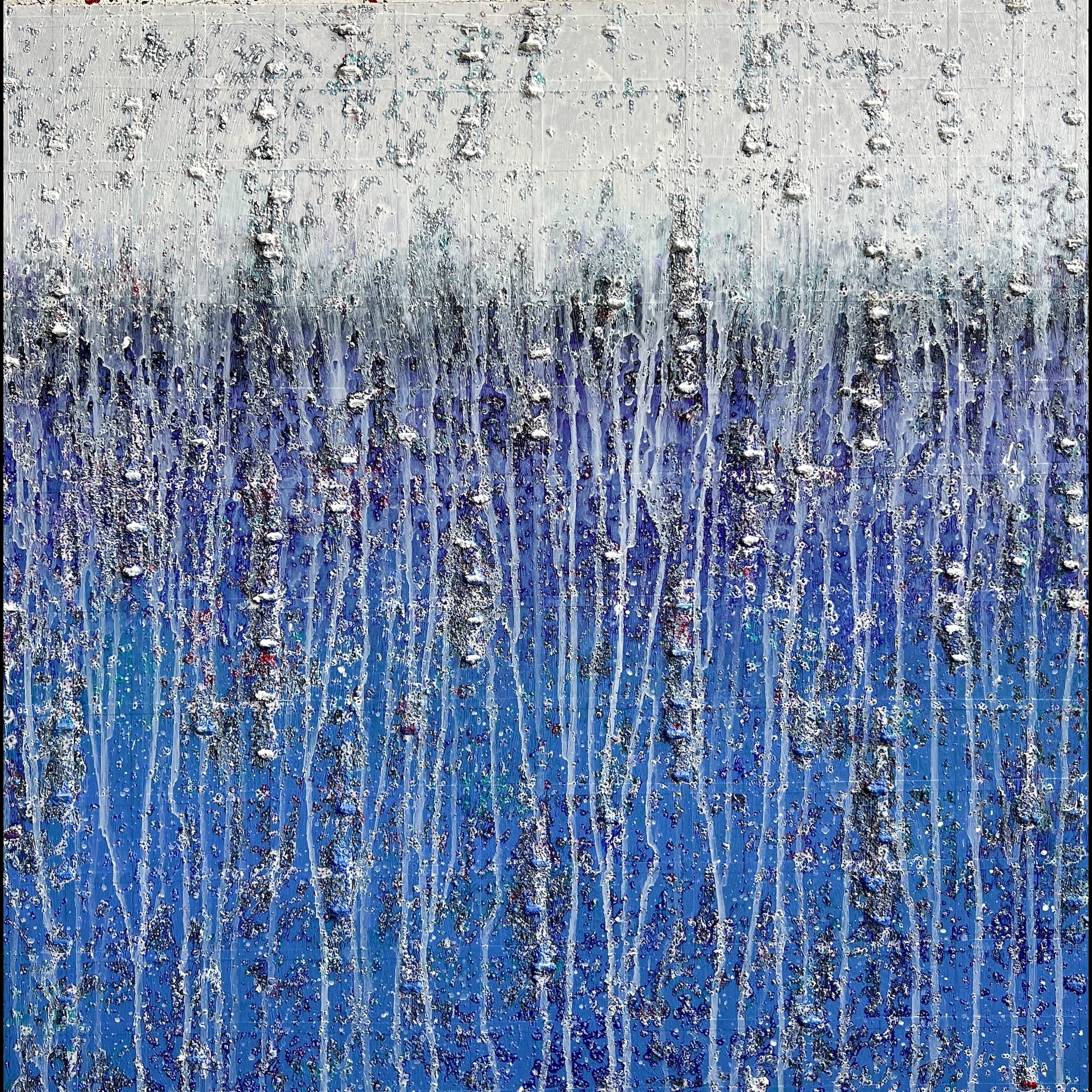 A textural art work with blue and white.