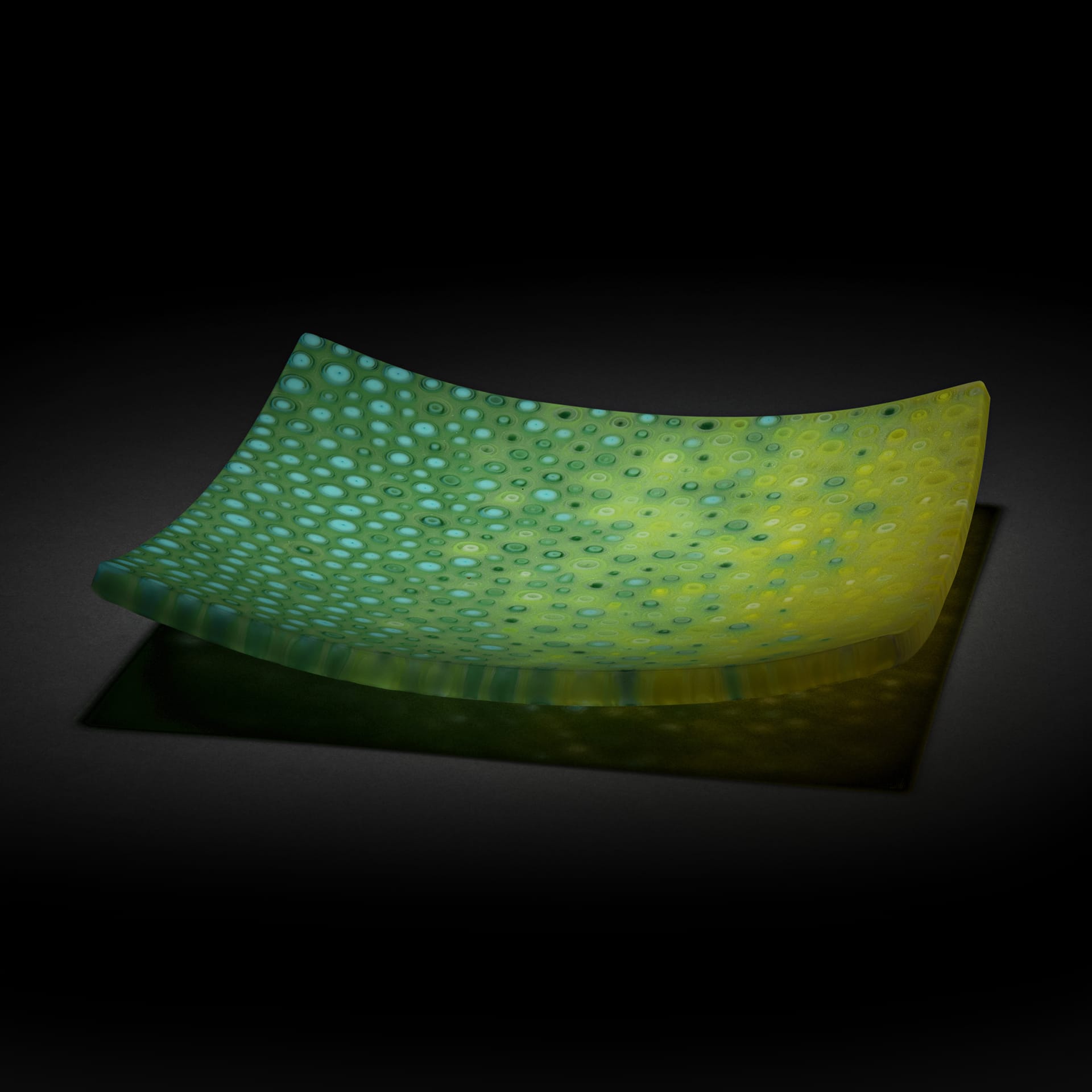 A green and yellow square glass tray.