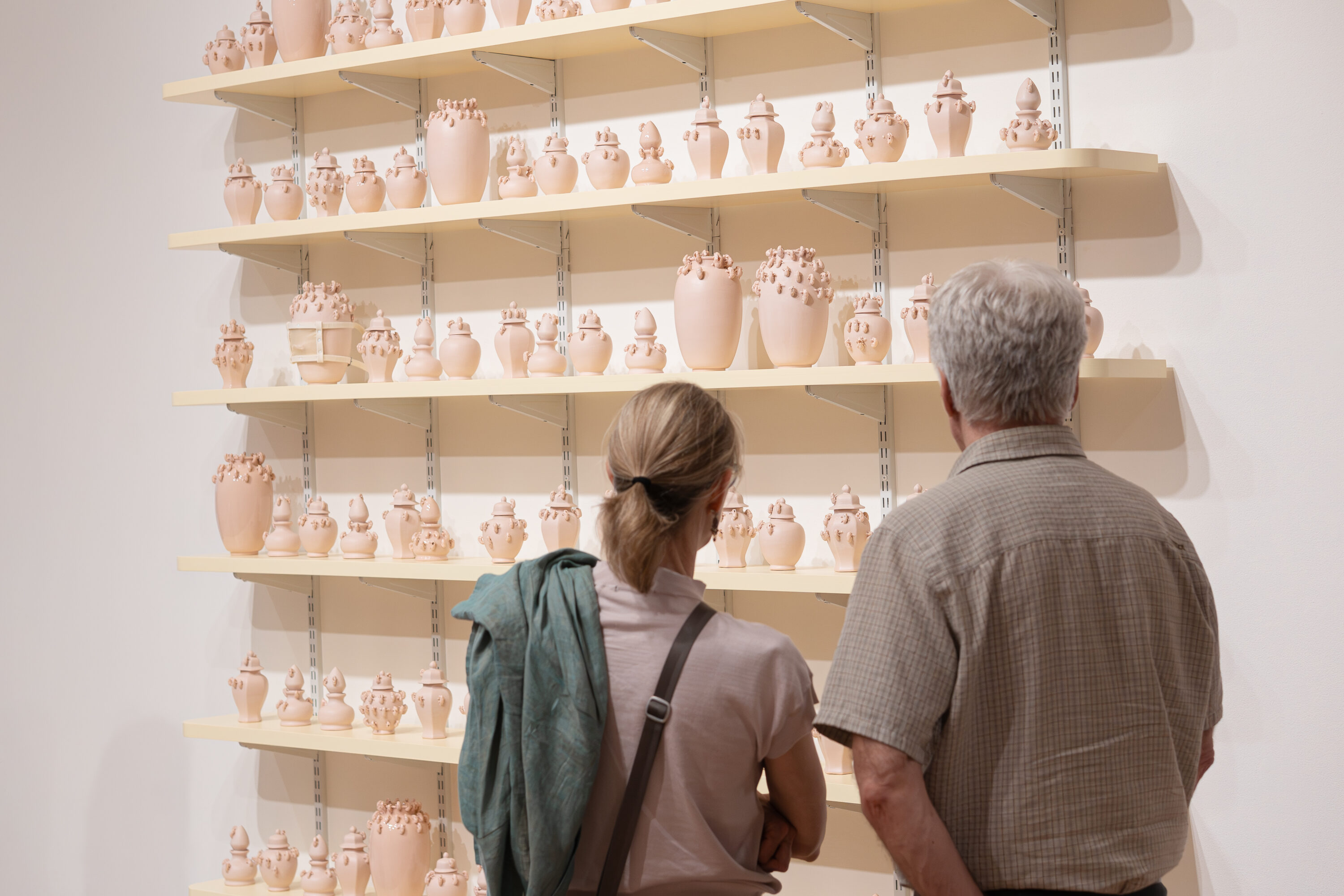 People looking at artwork in a gallery space.