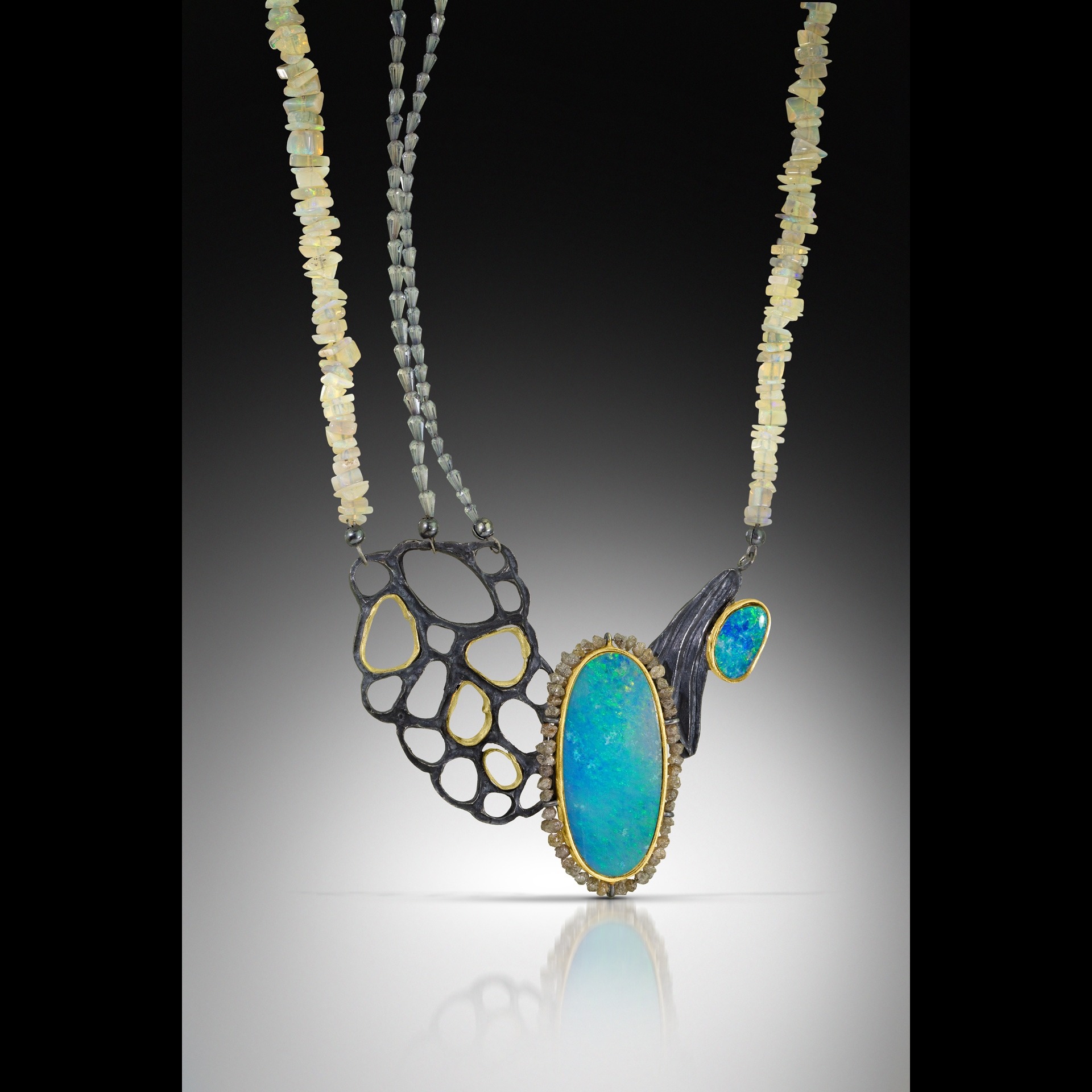 An abstract metal and teal necklace.