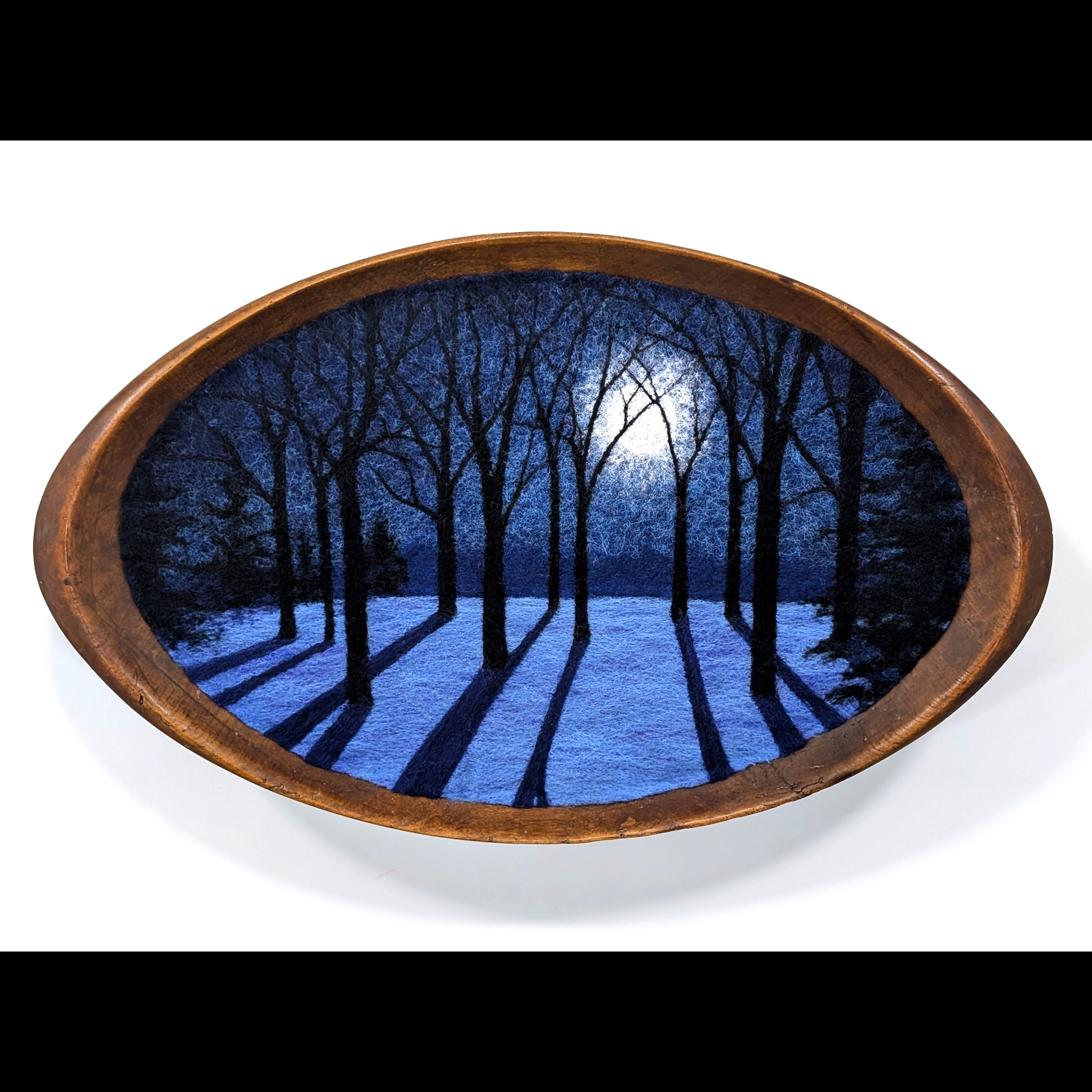 A forest on an oval frame.