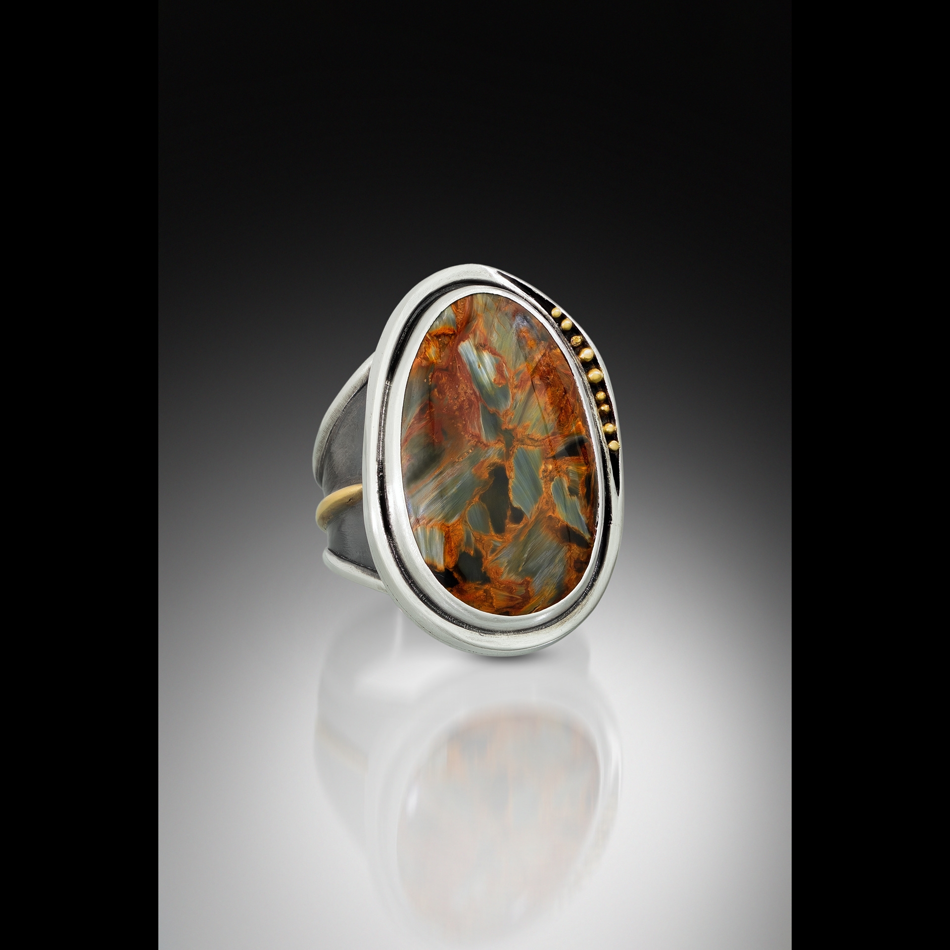 Silver ring with brown stone.