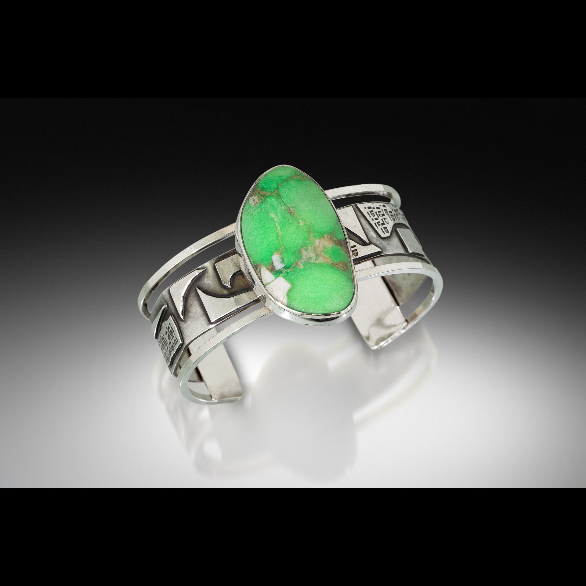 A silver ring with a green stone.