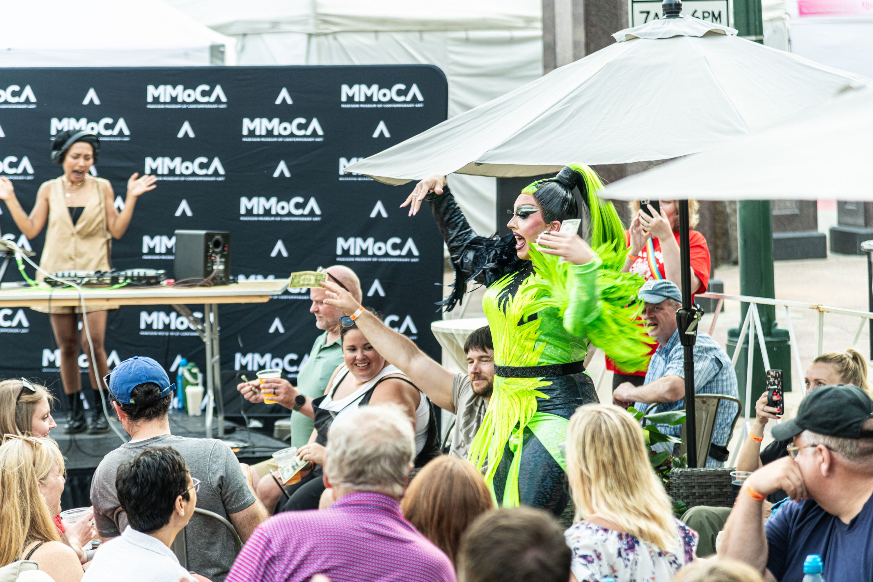 A DJ, Drag Queen, and audience at Muse at Art Fair on the Square