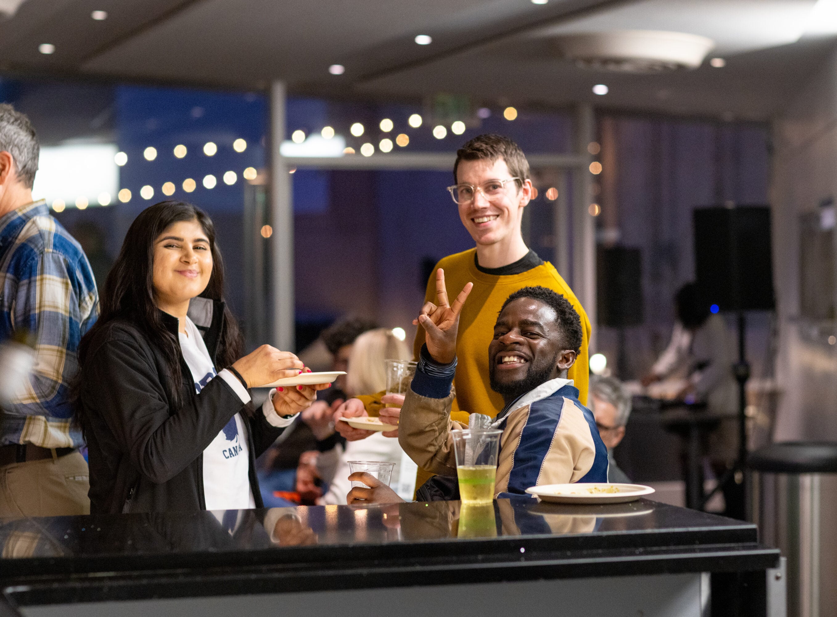 People smiling in a circle at a bar.