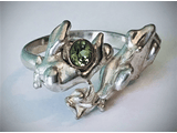 A silver ring with a green gem. 