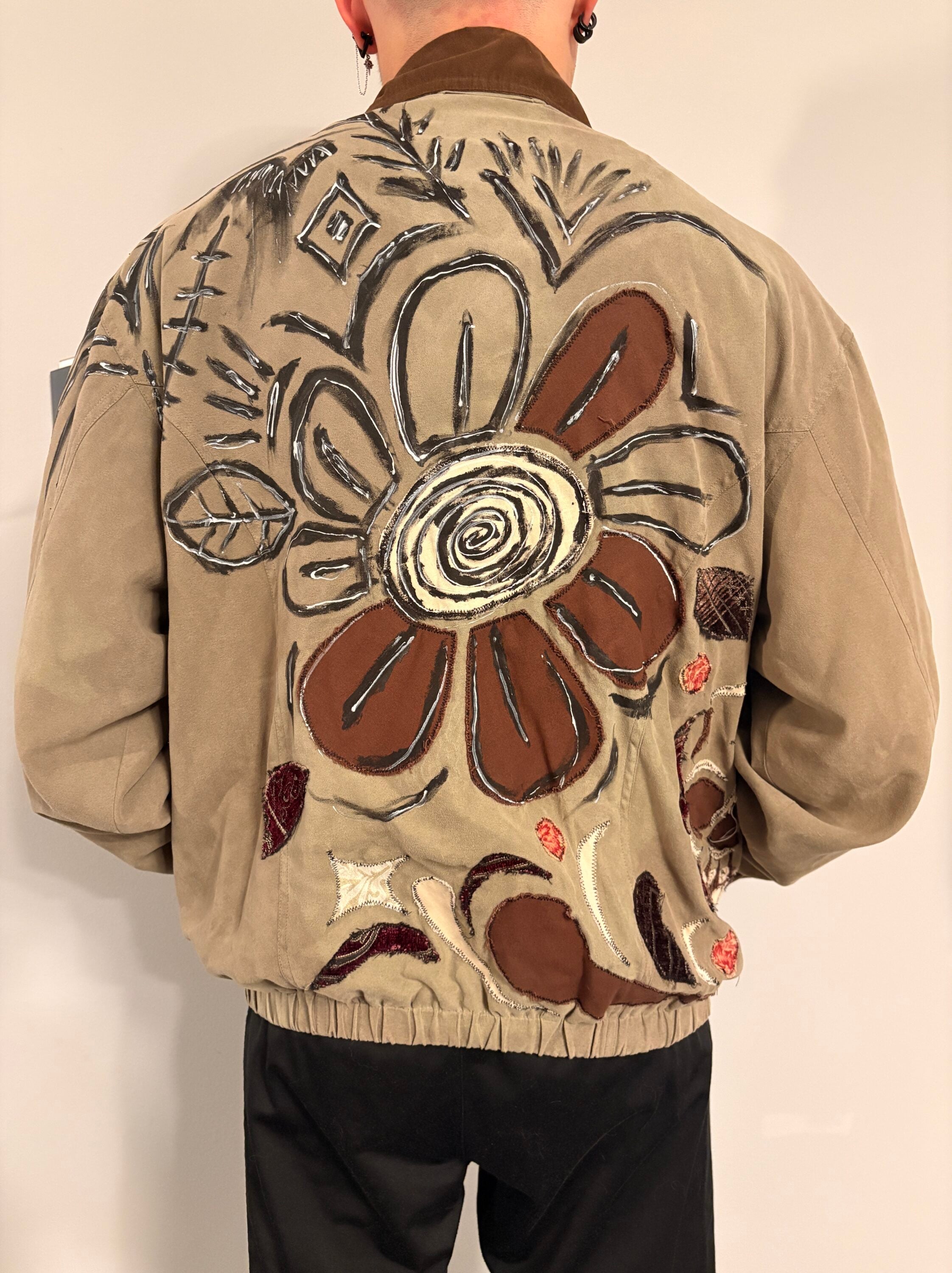 Flowers surrounded by abstract flowers on the back of a jacket.