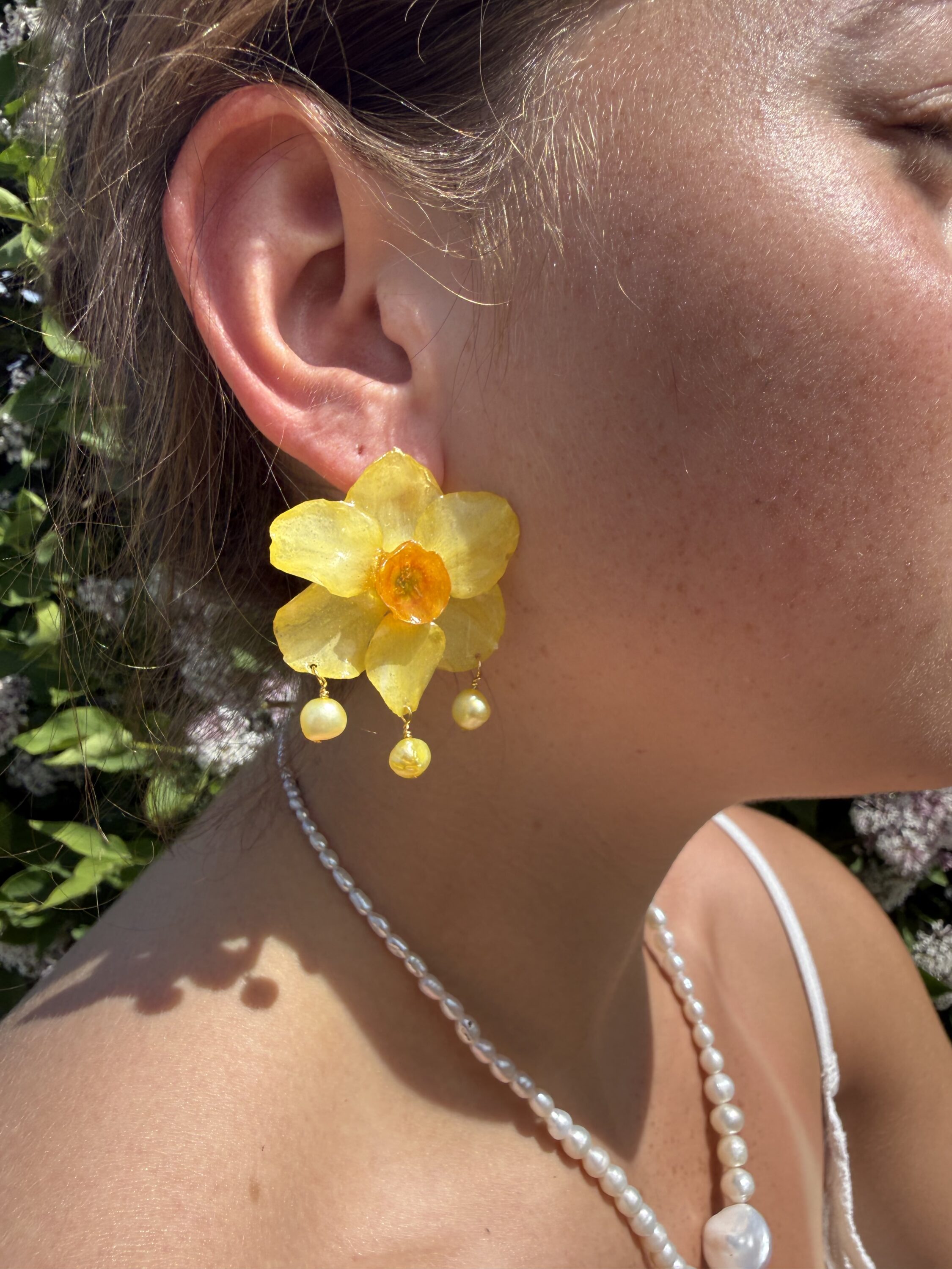 A yellow flower earring. 