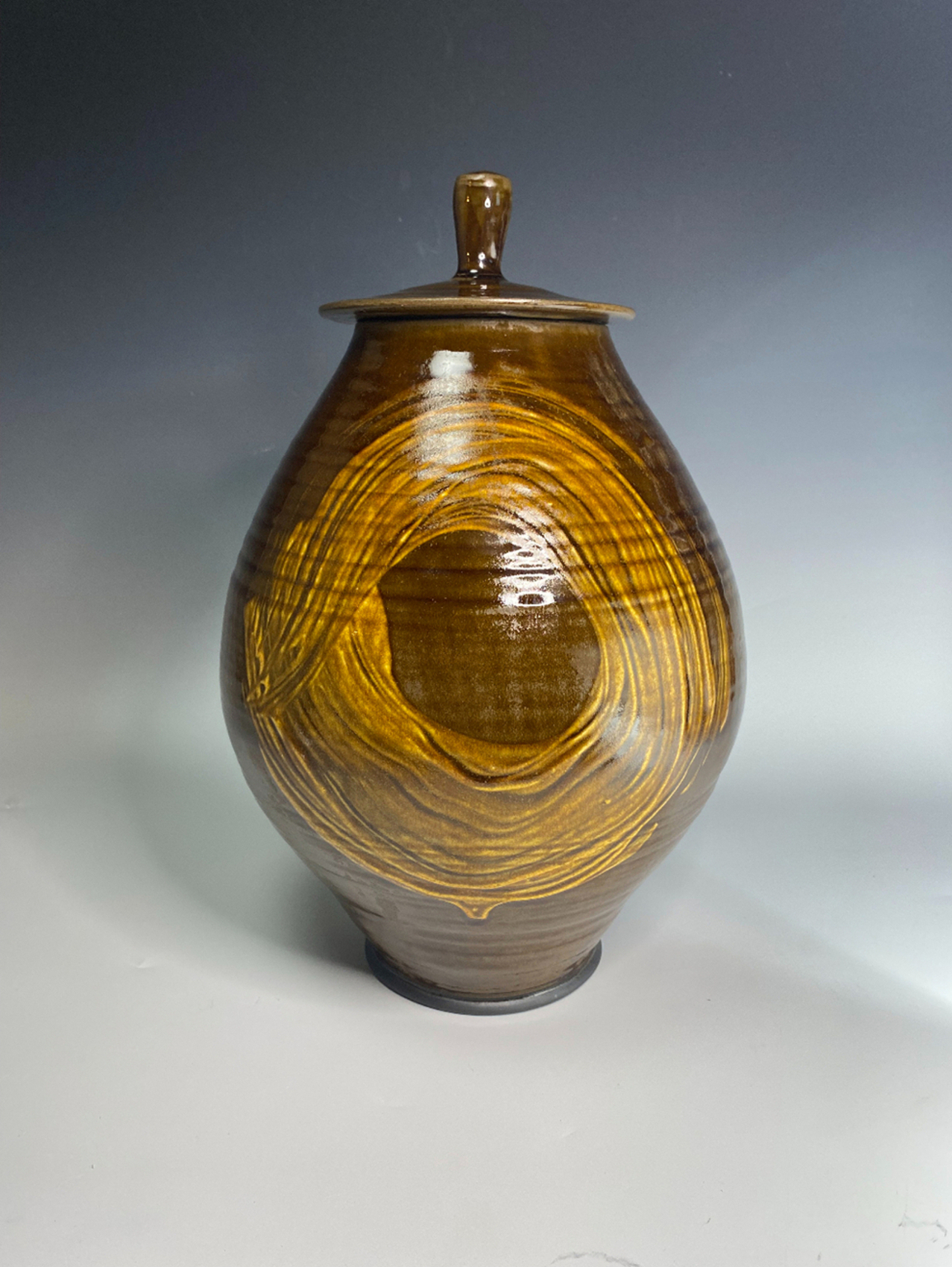 A brown vase with circle glazing.