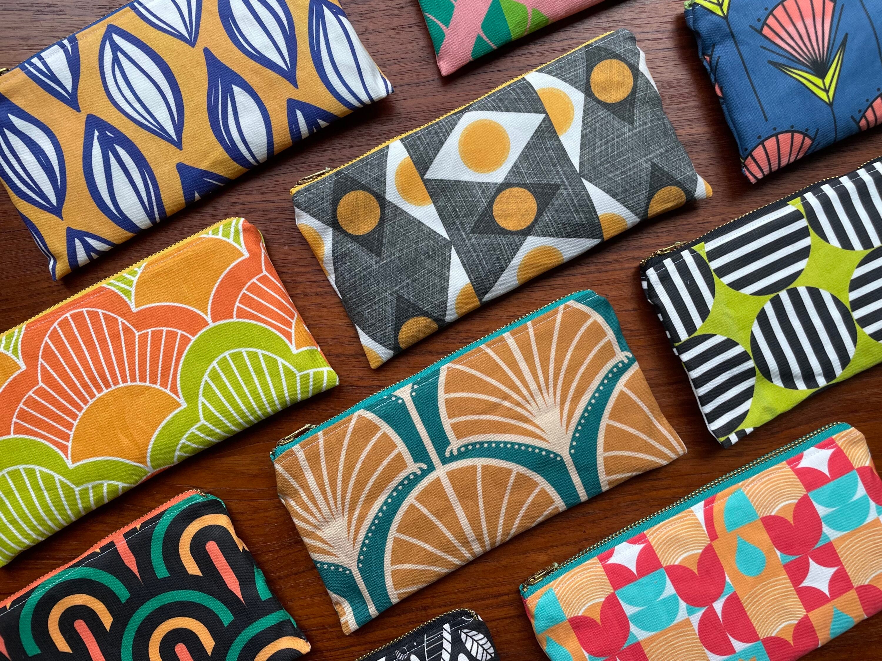 Many bright patterned hand bags. 